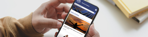 A person (only the hands are visible) accesses the 'Research Matters' website on their mobile phone.